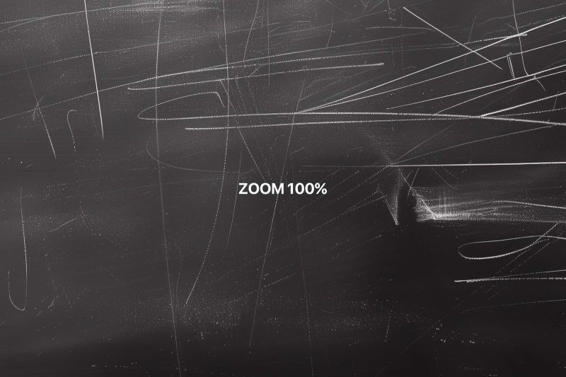 Close-up view at 100% zoom showcasing the intricate details of white chalk scratches on a blackboard texture, highlighting the quality and depth of the graphic design